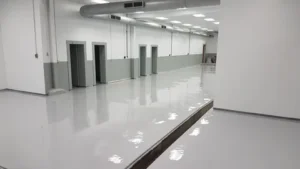 New commercial space with a freshly applied, light grey, high-gloss epoxy floor coating.